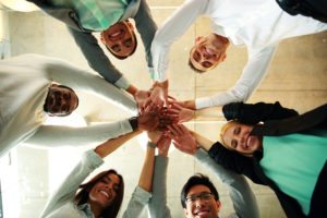 business people teamwork in an office with hands together